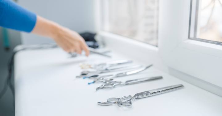 A person cleaning grooming tools